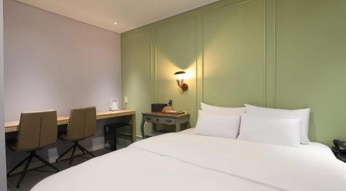 a hotel room with a bed and a desk at 아티초크 호텔 in Kajŏng-dong