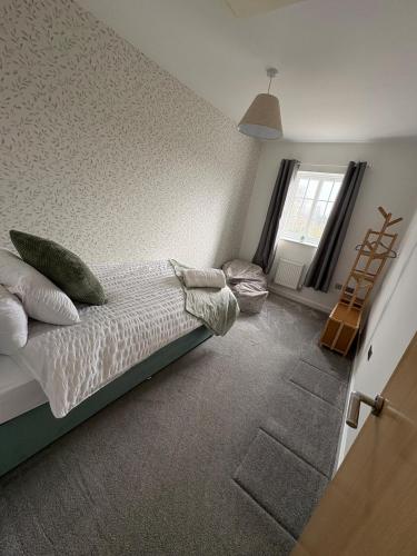 a bedroom with a bed and a ladder in it at Whistle Stop Terrace in Barnby Dun