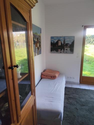 a small room with a bed and two windows at Tableaux in Château-Renault