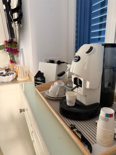a white coffee maker sitting on a counter at Capri Suite Dreams in Capri