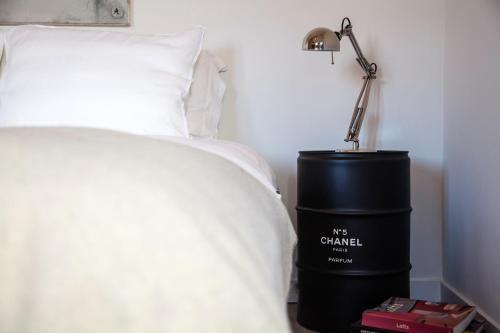a bedroom with a bed and a lamp on a table at Belle Chique - Maastricht in Lanaken