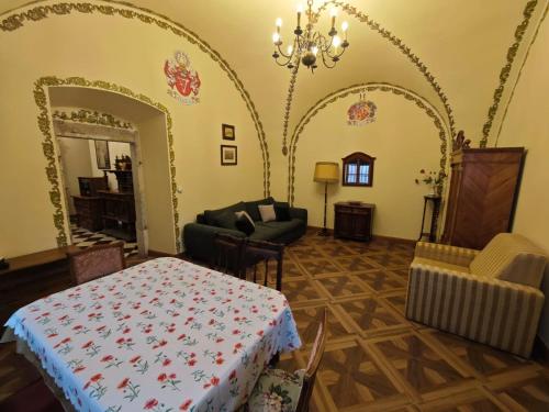 a living room with a table and a chair at Pałac Książęcy we Wleniu in Wleń
