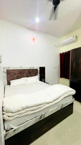 a bedroom with a large white bed in a room at Hotel Maa Bhagvati in Orchha