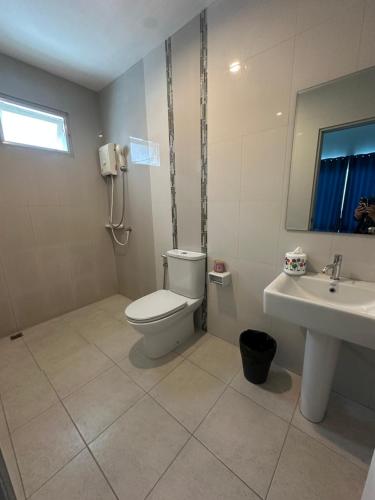 a bathroom with a toilet and a sink at Baanpeanutsvilla Huahin in Hua Hin