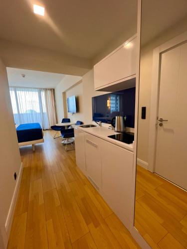 a kitchen with a sink and a counter top at New Orbi City Luxury Suites in Batumi
