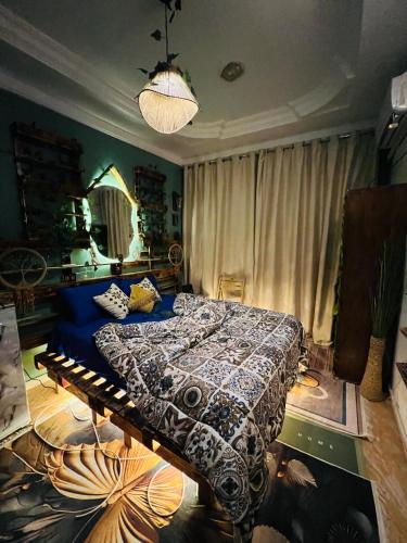 a bedroom with a bed with a blue comforter at Cabana House in Dahab
