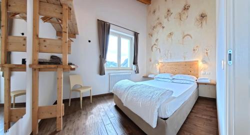 a bedroom with a bunk bed and a ladder at Oasi Da Vinci Apartments Lake Garda View in Tignale