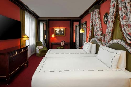 a hotel room with two beds and a television at L'Escape, a Luxury Collection Hotel, Seoul Myeongdong in Seoul