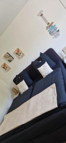 a bed with blue sheets and pillows on it at Ostsee No8 Eckernförde in Eckernförde