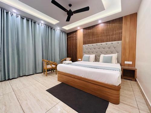 a bedroom with a bed and a ceiling fan at The Oakleaf Retreat - A Near Mall Road With Parking in Mussoorie