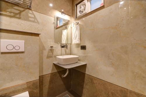 a bathroom with a sink and a mirror at Hotel City inn in New Delhi
