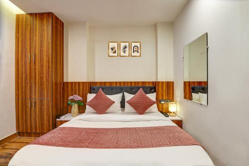 a bedroom with a large bed with red pillows at Hotel City inn in New Delhi