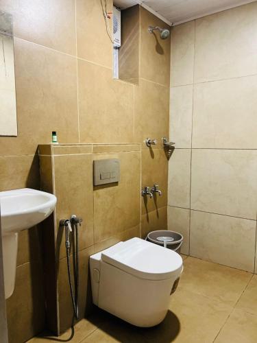 a bathroom with a toilet and a sink at Celestial Heights Kakkanad in Cochin
