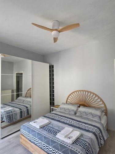a bedroom with two beds and a ceiling fan at B&B Dal Nonno in Riva del Garda