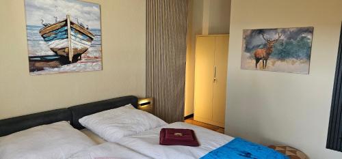 a bedroom with a bed and a picture of a boat at Ferienhaus Kiara in Feldberg