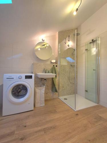 a bathroom with a washing machine and a sink at Apartment Romi in Bad Waldsee
