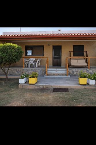 a house with a porch with a couch and a table at Farma Giannis in Sarti