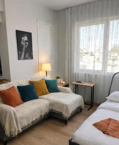 a living room with a couch and a window at Soydan World Travel in Antalya