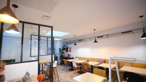 a restaurant with tables and chairs in a room at Espace entier Centre de Paris in Paris