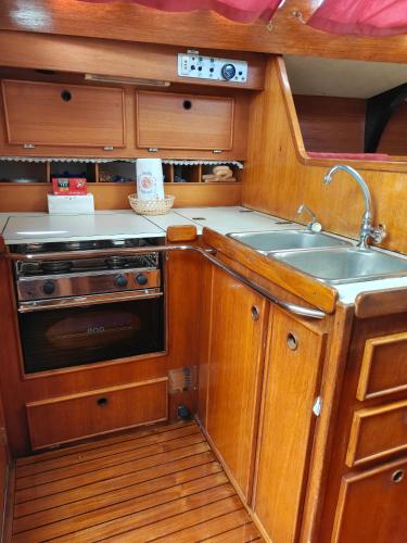 a kitchen with a sink and a stove at Dormire in Barca a Vela in Maratea