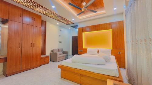 a bedroom with a bed and a chair in it at Mountain Springs Resort in Bāndarban