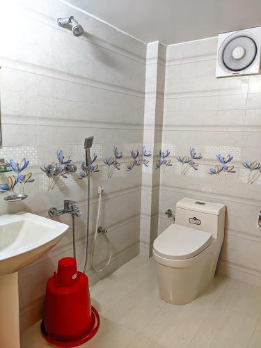 a bathroom with a toilet and a sink at Mountain Springs Resort in Bāndarban