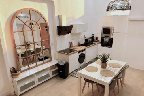a kitchen with a table and chairs and a counter at Le cocon près d'Albi in Saint-Grégoire