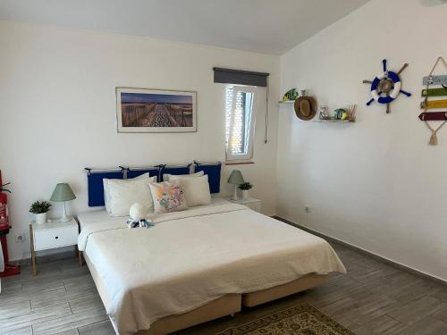 a bedroom with a large bed in a room at Óasis - Pedras D' El Rei T0 in Santa Luzia