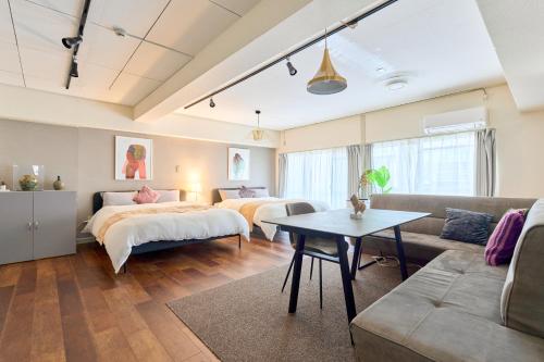 a living room with two beds and a couch at Tokyo Base Meguro in Tokyo