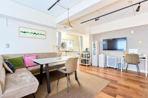 a living room with a couch and a table at Tokyo Base Meguro in Tokyo