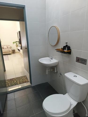 a bathroom with a toilet and a sink and a shower at Dirindu homestay in Temerloh