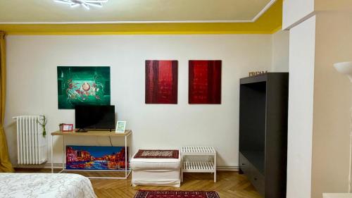 a bedroom with three paintings on the wall at Behind On The Canalside Venice in Venice