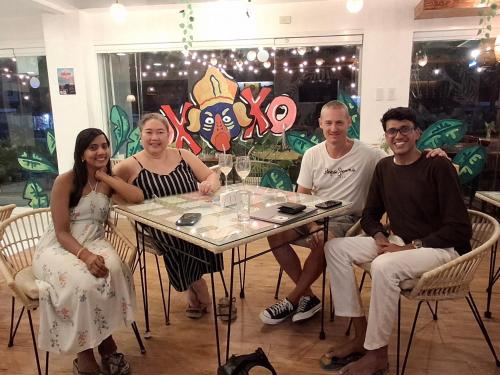 a group of people sitting at a table at Wanderlust Bed and Breakfast Puerto Princesa in Puerto Princesa City