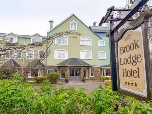 a large green building with a sign in front of it at Brook Lodge Boutique Hotel in Killarney