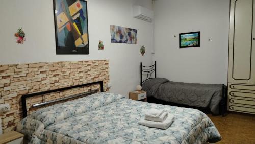 a bedroom with a bed and a brick wall at La Casetta Di Cotignola in Cotignola