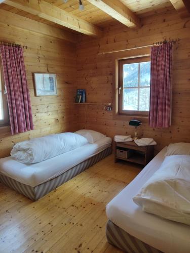 a bedroom with two beds in a log cabin at Chalet Talblick in Bad Kleinkirchheim