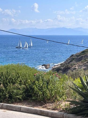 a group of sailboats in the ocean with a beach at Rafina's PARADISE VIEW!!Walking access to the Port!!! Amazing Seaview!!!Steps from the Beach, 2 min walk!!WIFI 300Mbps! The Lux Seaside Retreat! in Rafina