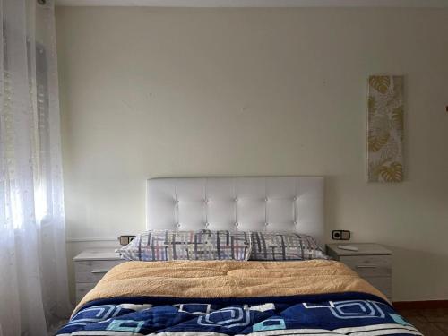 a bedroom with a large bed with two night stands at Large and cozy studio in Piera