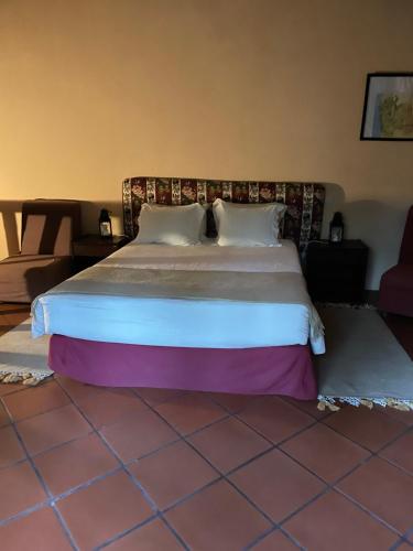 a bedroom with a large bed in a room at Casa do Palheiro de Cima in Geres