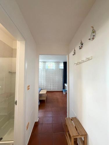 a hallway with a room with a table and a door at Bio&B Acquaviva in Otranto