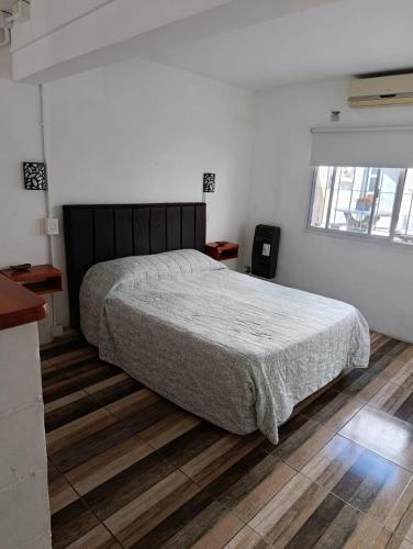 a bedroom with a large bed and a window at La soñada 1 in Villa Mercedes