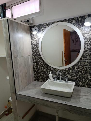 a bathroom with a sink and a mirror at La soñada 1 in Villa Mercedes