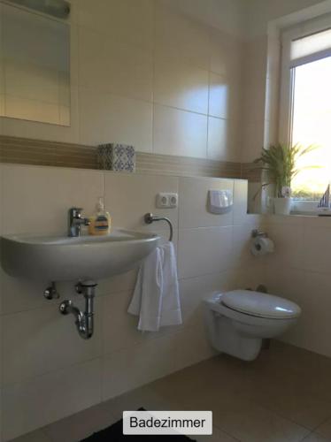 a bathroom with a sink and a toilet at Ferienwohnung ANKER in Lubmin