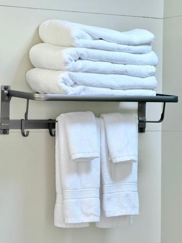 a pile of towels on a shelf in a bathroom at Araka Homes-Westlands in Nairobi