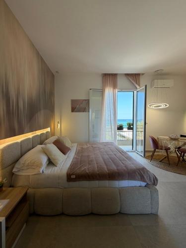 a large bedroom with a large bed and a table at Suites Domus Fysi in Palermo