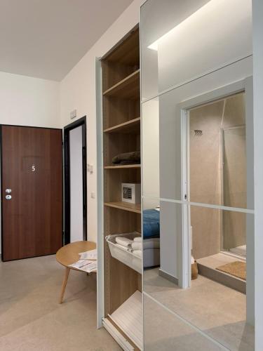 a room with a glass closet with a door at Suites Domus Fysi in Palermo