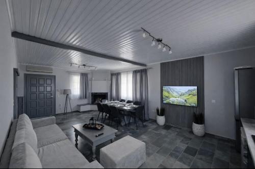 a living room with a couch and a table at Green Garden Private Villa in Porto Heli