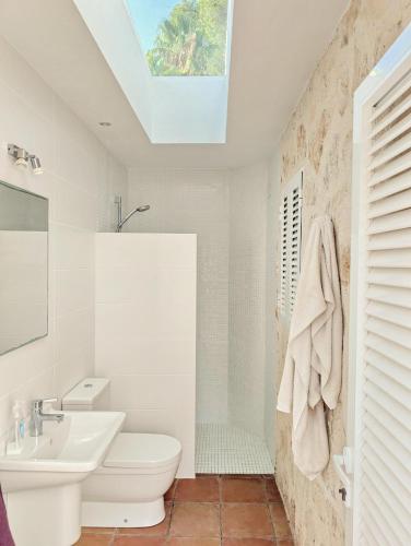 a white bathroom with a sink and a toilet at Villa Erika by Solidays in Moraira