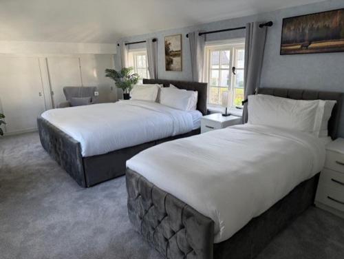 two beds in a hotel room with two beds sidx sidx sidx at Luxury 6 bed house by the sea in Rhos-on-Sea