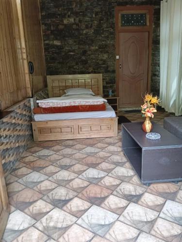 a bedroom with a bed and a couch and a door at Sai Palace in Darjeeling
